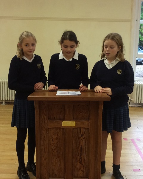 Three pupils at lectern